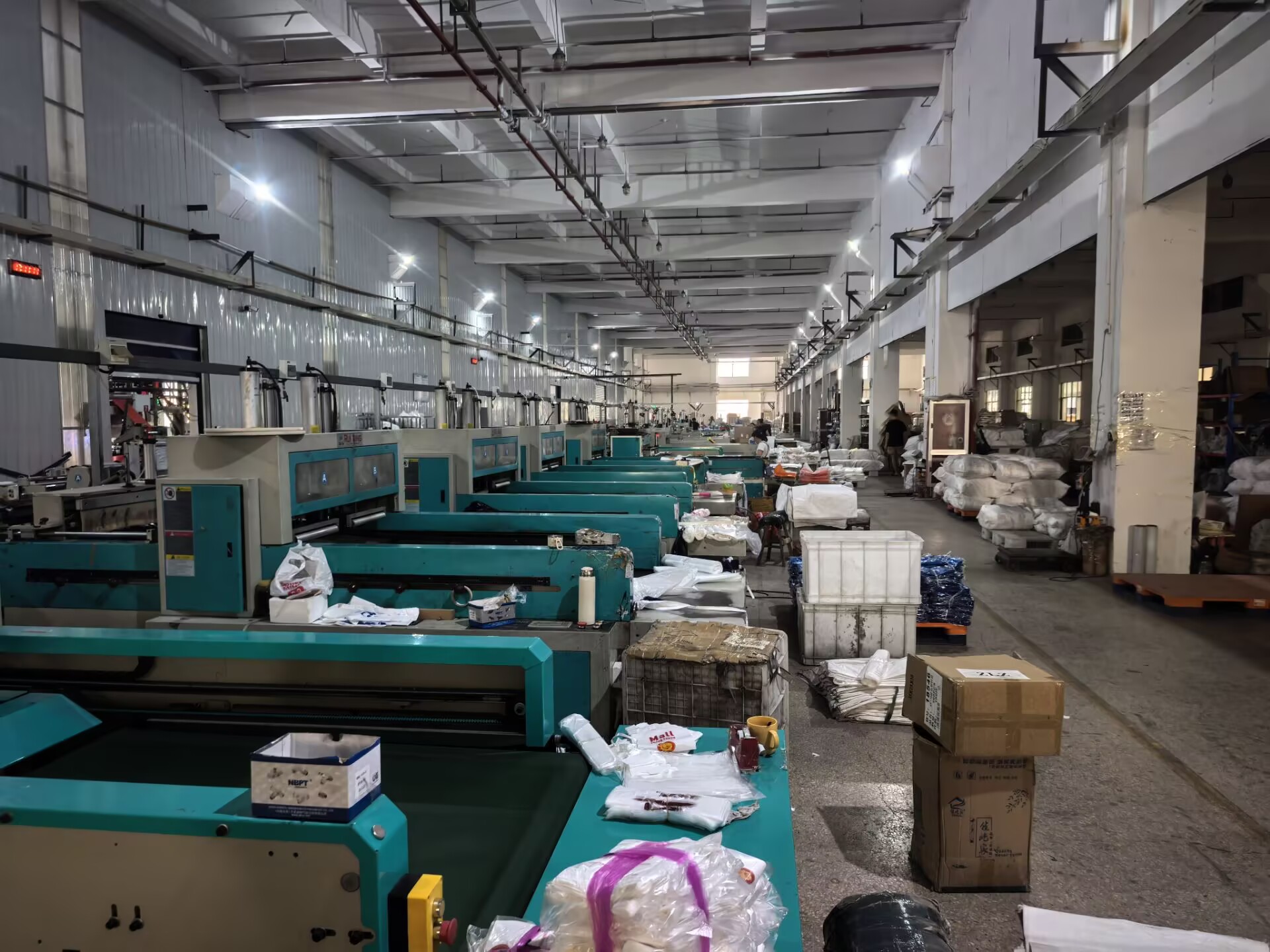 Rows of turquoise bag production machines